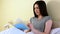 Woman reading a blue book in bed