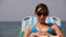 Woman reading book on the beach