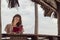 Woman reading a book at beach bar counter while on vacation