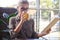 Woman reading book while drinking herbal tea at cafe