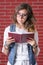 Woman reading a book with eyesight glasses