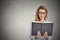 Woman reading book having thought