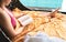 Woman reading book by the pool. Lady enjoying novel and laying on towel and sun lounger chair in hotel, resort or holiday villa.