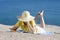 Woman reading a book at the sea