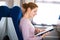 Woman reading a book while on a train