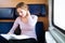 Woman reading a book while on a train