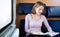 Woman reading a book while on a train