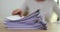 Woman reading documents at table in office closeup