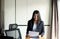 Woman reading employee termination letter and holding box and equipment from work,Unemployment job concept