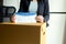 Woman reading employee termination letter and holding box and equipment from work,Unemployment job concept