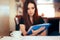 Woman Reading Important Documents in a Restaurant