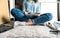 Woman reading instructions assembling DIY furniture at home.