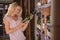 Woman reading the label behind a bottle of wine