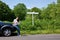 Woman reading a map by the roadside with blank sig