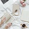 Woman reading a novel on her bed on a Sunday afternoon