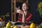 Woman reading a romantic book in a cozy warm atmosphere enjoying the autumn mood. Rustic table with stack of books