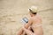 woman reading tablet reader on the beach