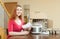 Woman reading warranty card for new slow cooker