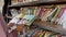 a woman reads a book in front of a pile of books in a mobile library car