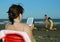 Woman reads the ebook on the beach in the summer