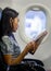 Woman reads a journal in a plane