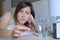 Woman ready to eat medicine pill lying in bed