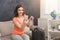 Woman ready for travel, sitting with suitcase