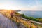 Woman rear view watching sunset landscape Conero natural park dramatic coast headland rocky cliff adriatic sea beautiful sky