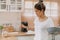 Woman rearrange equipments items and cleaning the kitchen.