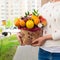 Woman received a new original unusual fruit bouquet, outdoors. C