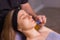 Woman receives facial cupping massage facial rejuvenation at acupuncture wellness spa.