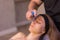 Woman receives facial cupping massage facial rejuvenation at acupuncture wellness spa.