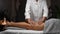 Woman receiving anti cellulite massage in spa center, masseur doing professional legs massage