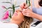 Woman receiving false eye lashes - beauty studio