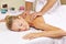 Woman receiving nape massage in spa