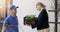 Woman receiving online grocery order box from delivery service courier