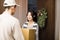 Woman receiving package from delivery man