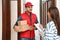 Woman receiving parcels from delivery service courier