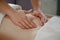 Woman receiving professional belly massage in wellness center, closeup