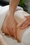 Woman receiving professional belly massage in wellness center, closeup