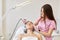 Woman receiving ultrasonic facial exfoliation at cosmetology salon. Procedure clearing clogged pores, ultrasonic treatment for