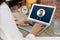 Woman receiving video call from colleague at table in office