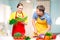 woman with a recipe book, a man cuts vegetables cooked together a salad