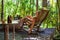 Woman reclining and relaxing at wooden armchair in outside bathroom