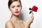 Woman with red Attractive naked shoulders luxury look flower red lips light
