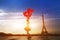 Woman with red balloons near Eiffel tower in Paris