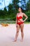 Woman in red bikini pretty with sunshine on beach