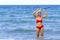 Woman with red bikini shape pretty on beach at Ban Krut