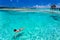 Woman in red bikini swimming in a coral lagoon