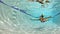 Woman in a Red Bikini Swimming Underwater